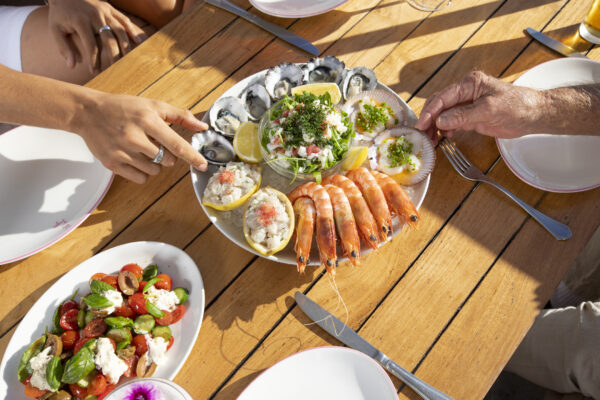 People eating a cold seafood platter at The Tropic