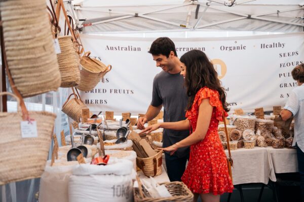 Couple exploring the market stalls of fresh produce and local artisan creations